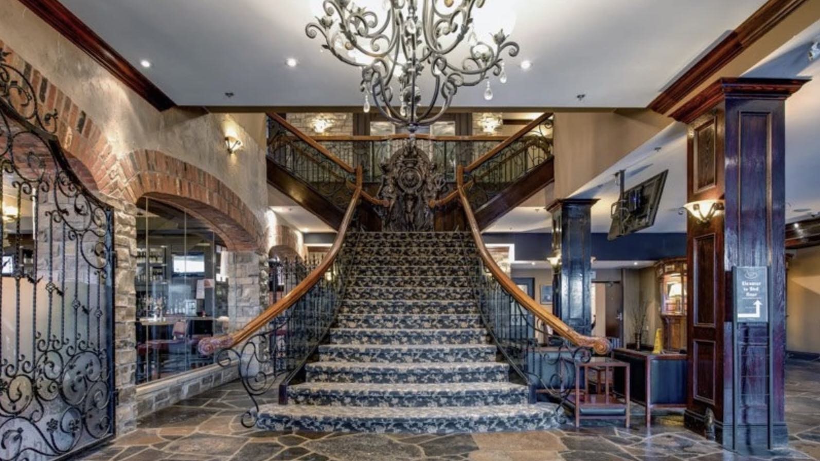 Stone Mill Inn lobby staircase at one of th ebest boutique hotels in Niagara Falls