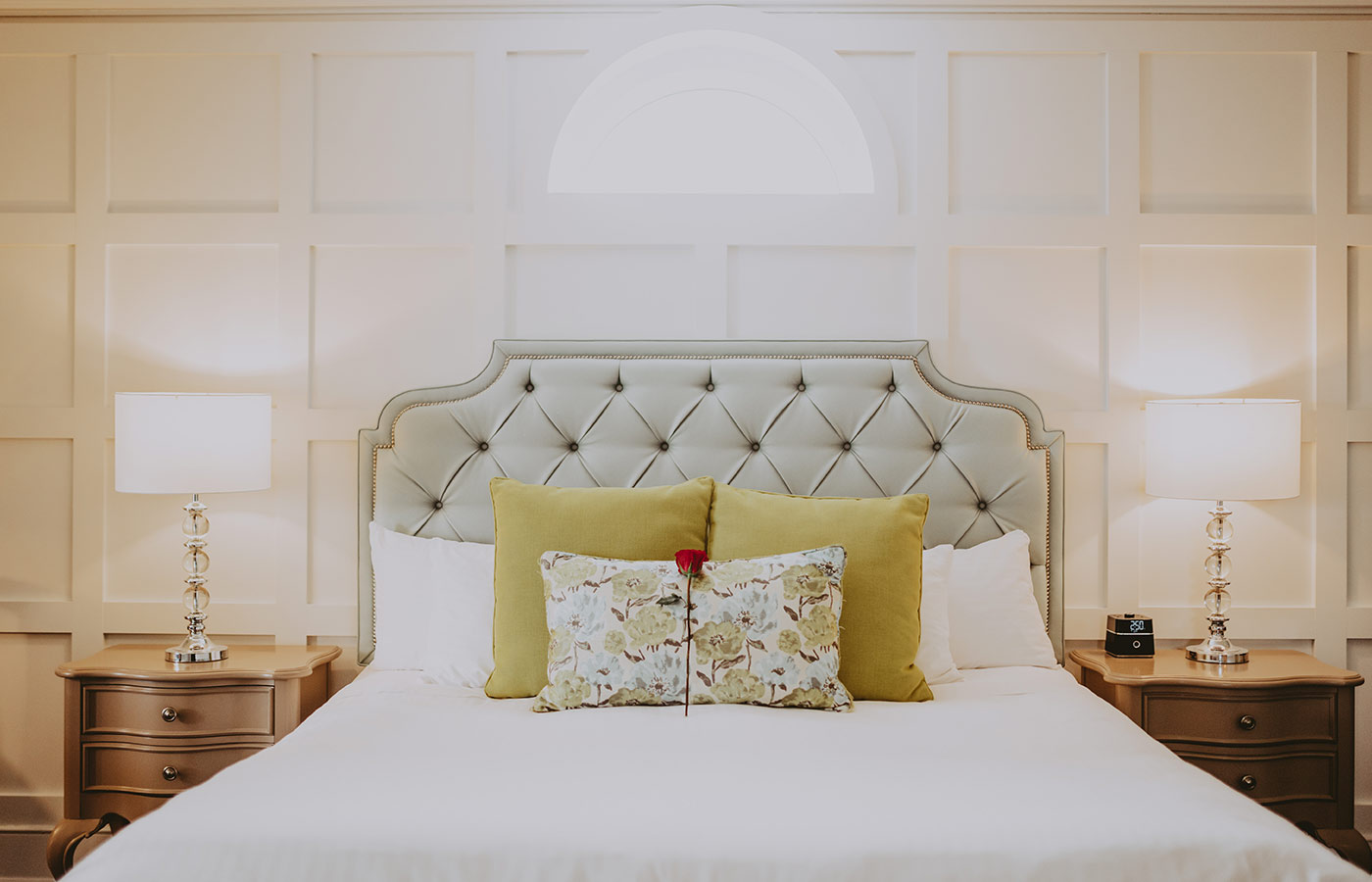 Queen’s Landing bedroom with rose on bed