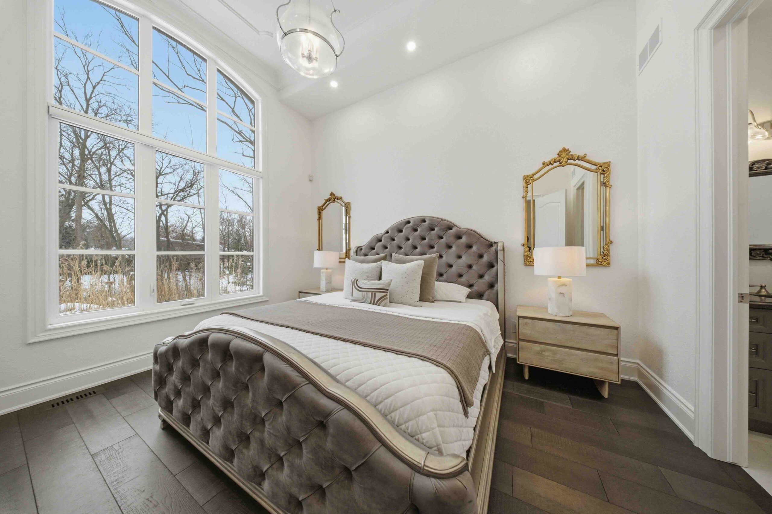 The Primary Bedroom with view of trees